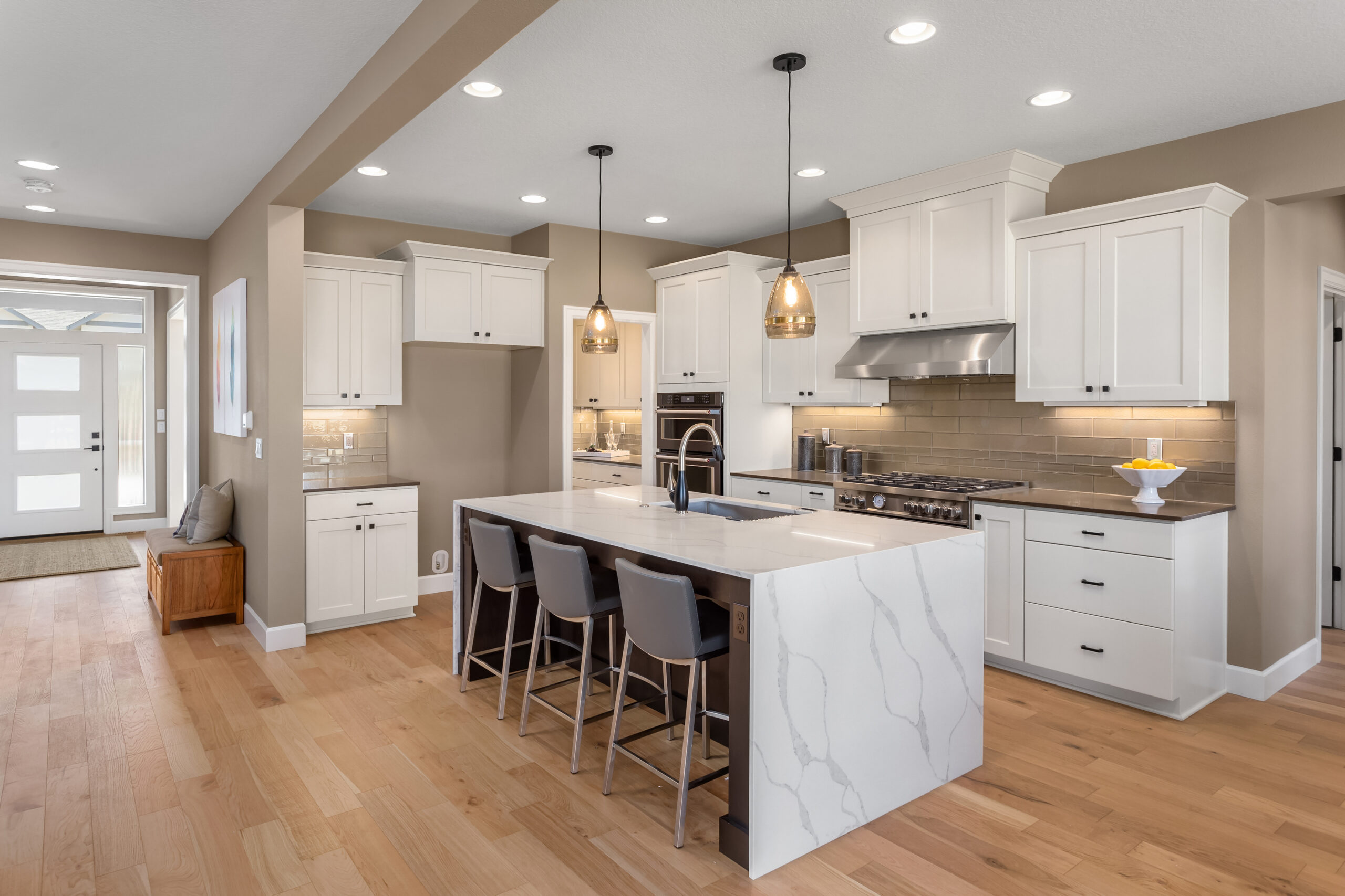 Home beautiful kitchen in new luxury home with waterfall island, quar